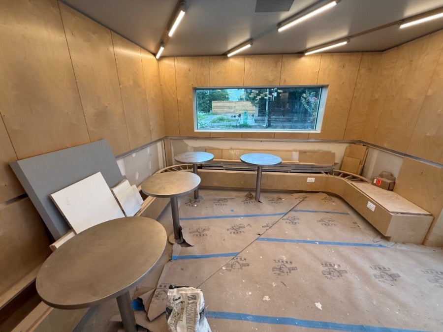 Interior with plywood walls and long light track